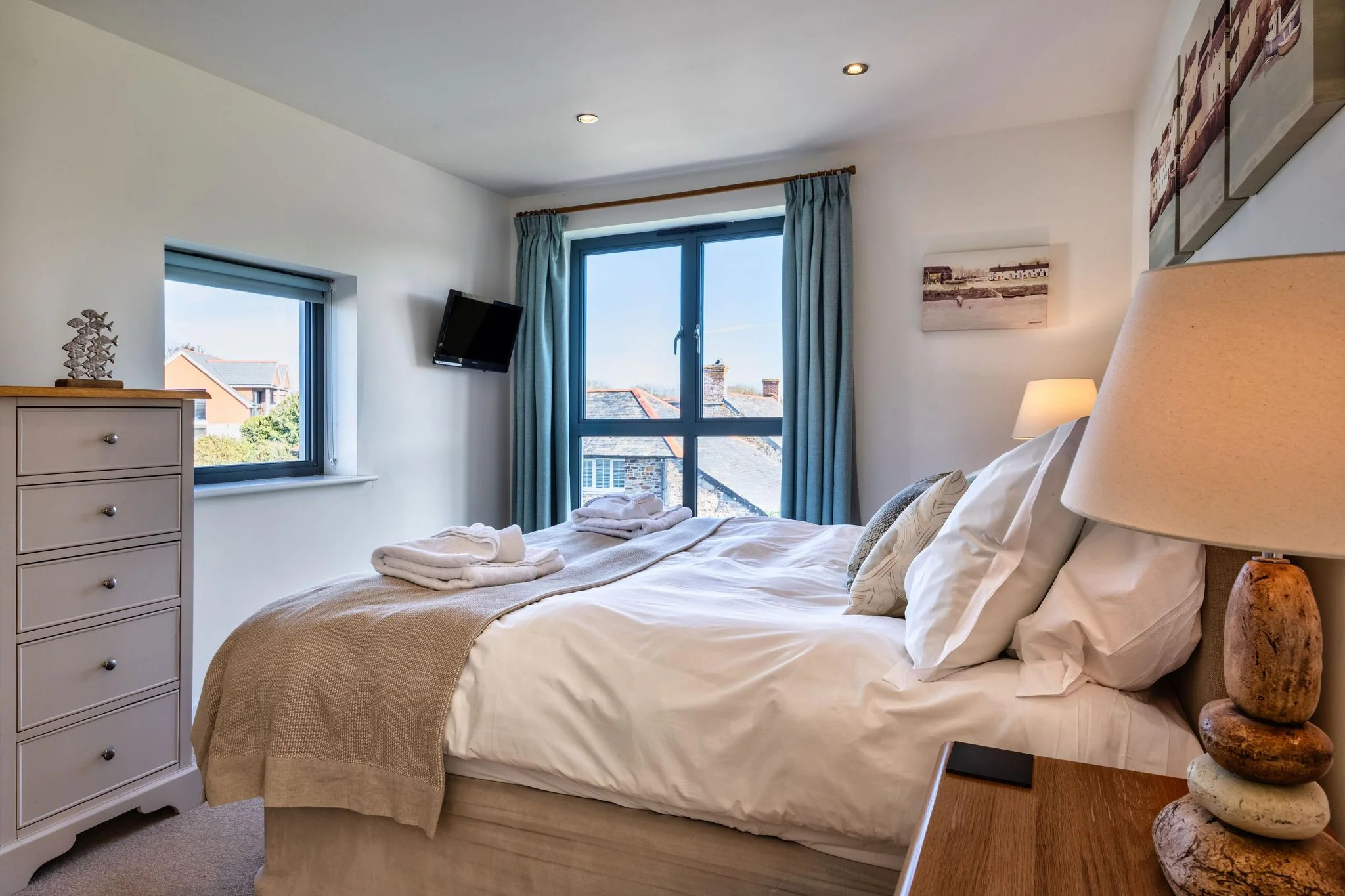 Arundell bedroom with a wall-mounted TV and chest of drawers