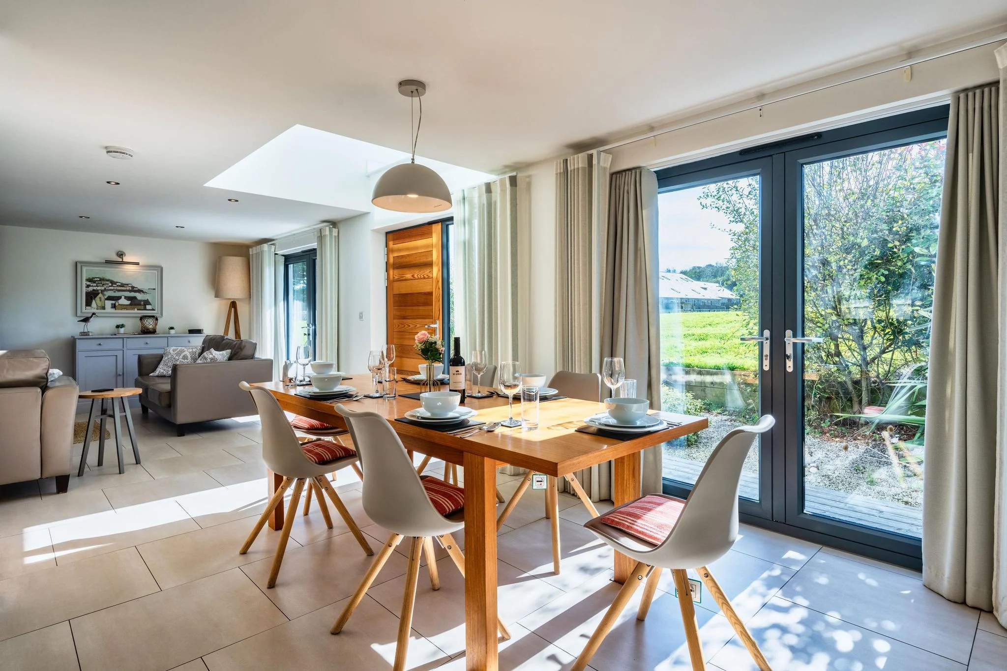 Arundell dining area with a table beside garden bifold doors
