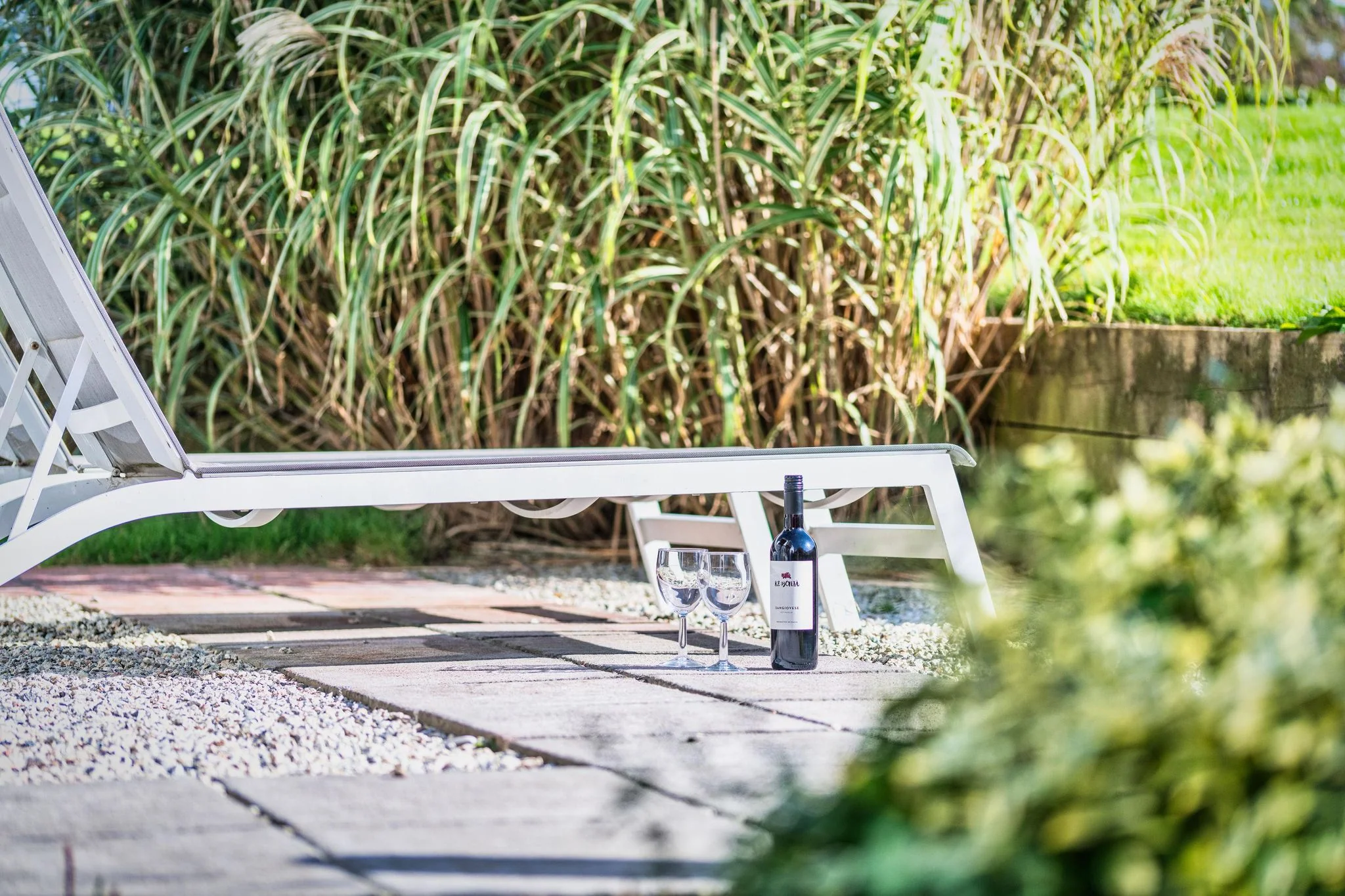 Arundell garden with a sun lounger among coastal grasses