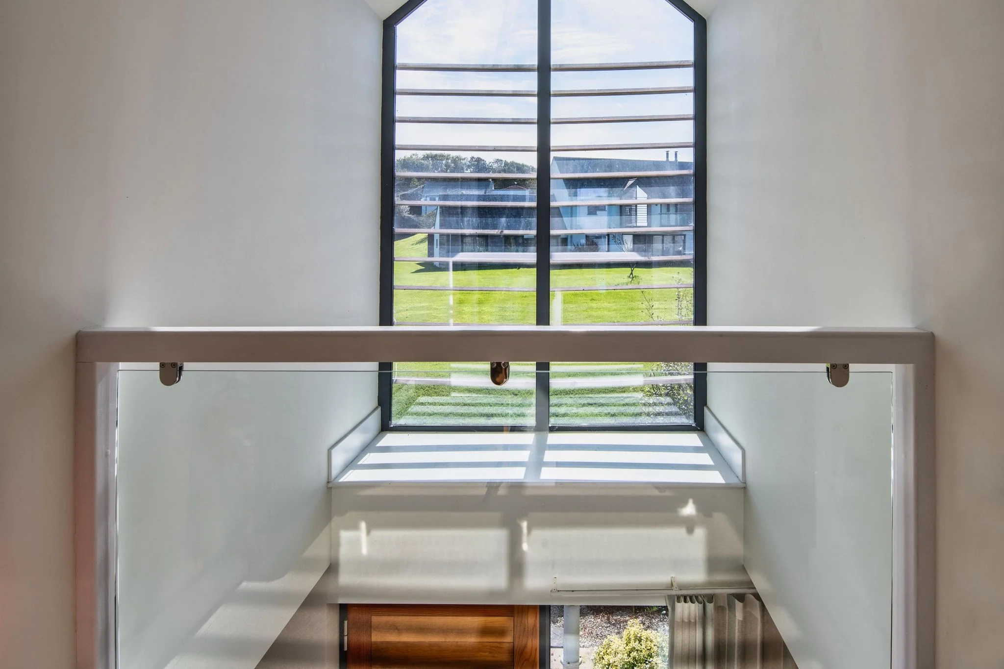 Arundell mezzanine bedroom with a glass balustrade