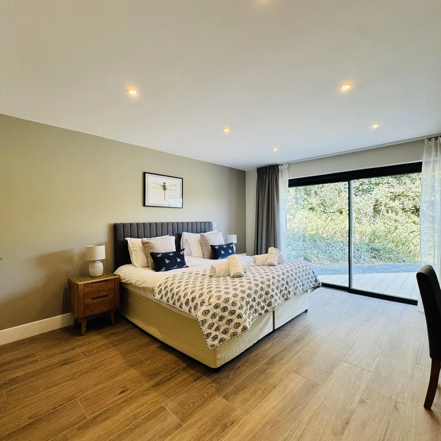 A bedroom at Nan's House with sliding doors opening straight onto the decking