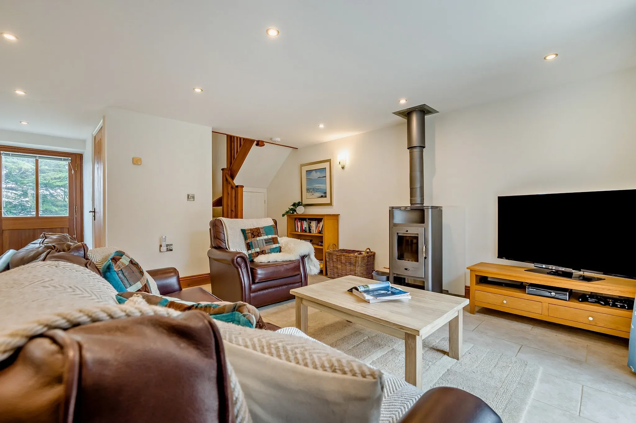 The living area at Sand Parks with its freestanding multi-fuel burner on a slate hearth