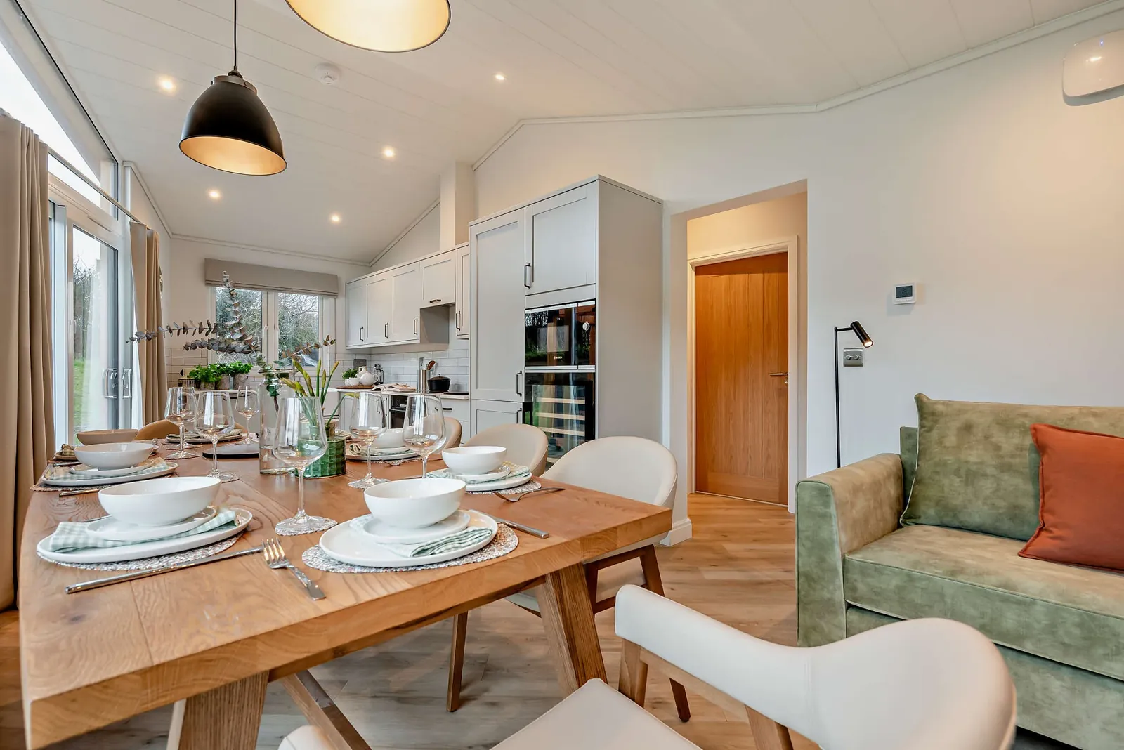 Inside a Trelowen lodge — open-plan living with full-height windows