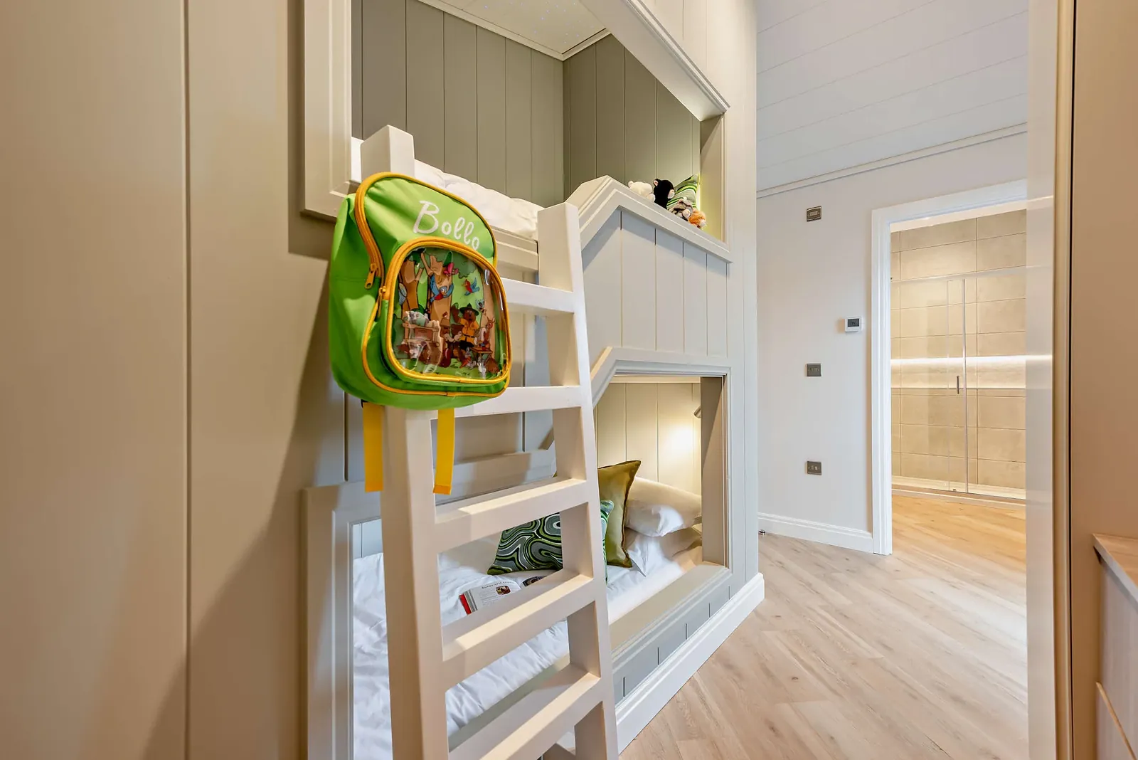 Built-in bunk beds in the third bedroom of a Trelowen lodge, with the shower room beyond