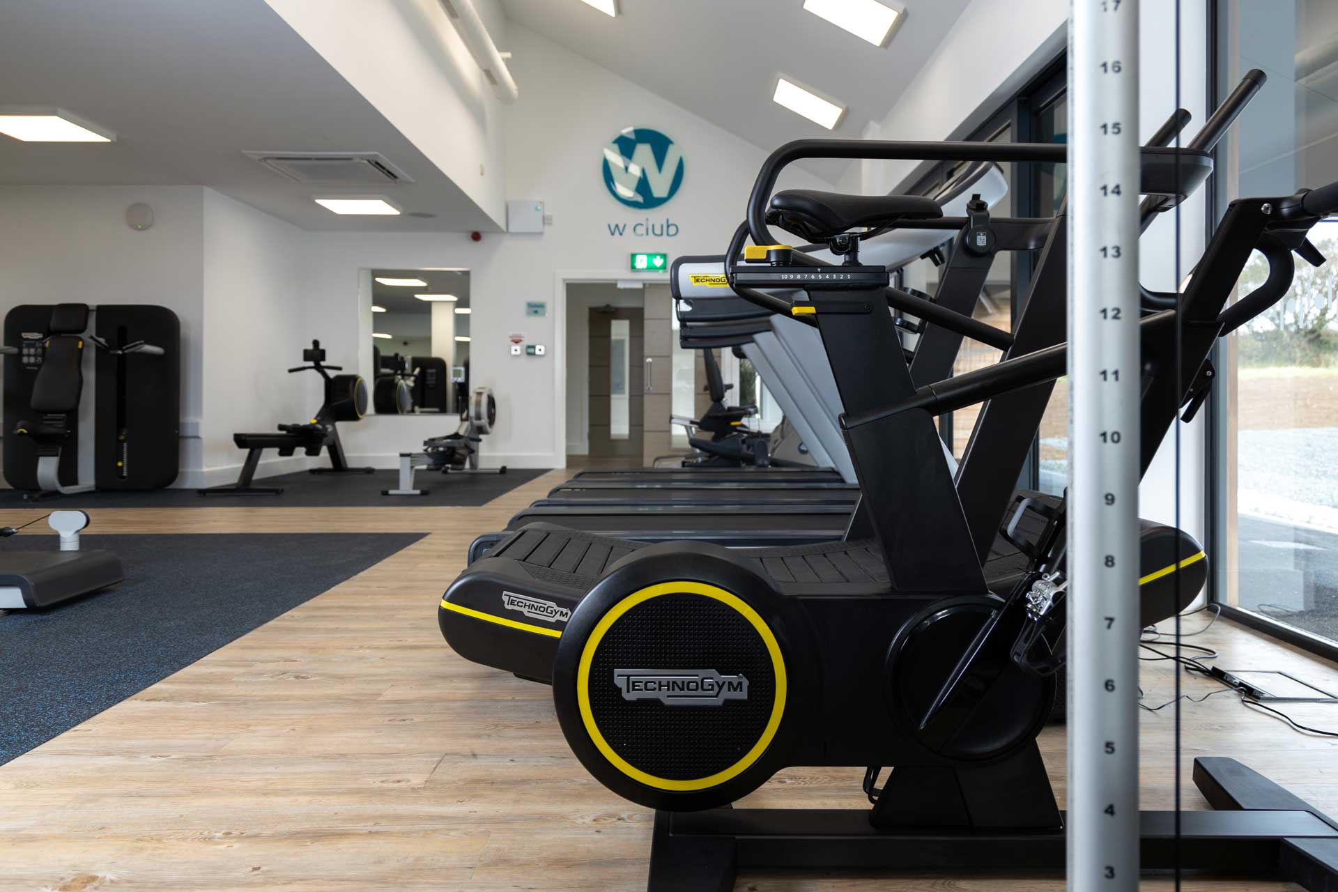 Row of Technogym treadmills and cardio equipment in the fitness suite at The W Club, Whalesborough, Bude Cornwall