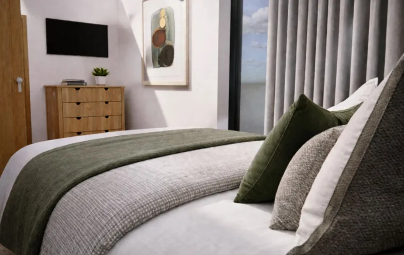 Gwelva Holiday Homes &mdash; bedroom with a floor-to-ceiling window and soft green accents