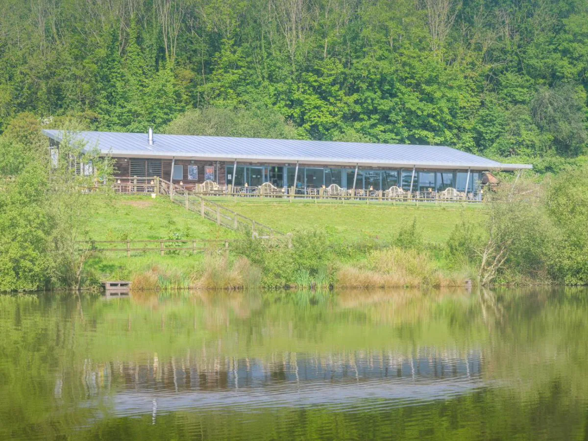 The Weir Restaurant seen across the estate lake at Whalesborough Farm, Bude Cornwall