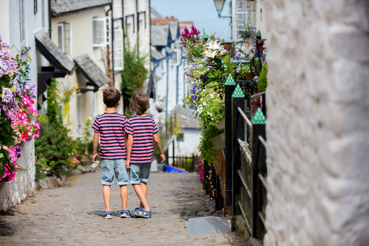 Beautiful family, walking on the streets of Clovelly, nice old village in the heart of Devonshire, England